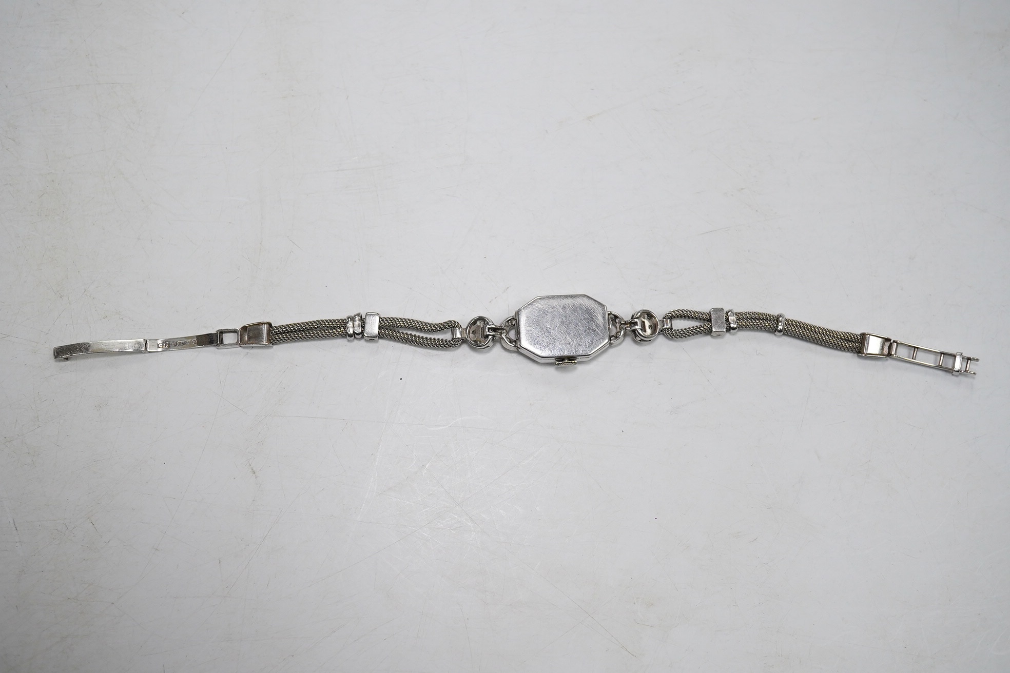 A lady's 1950's white metal and diamond cluster set manual wind cocktail watch, on a 9ct white gold bracelet, overall length 17.5cm, gross weight 17.1 grams. Condition - fair